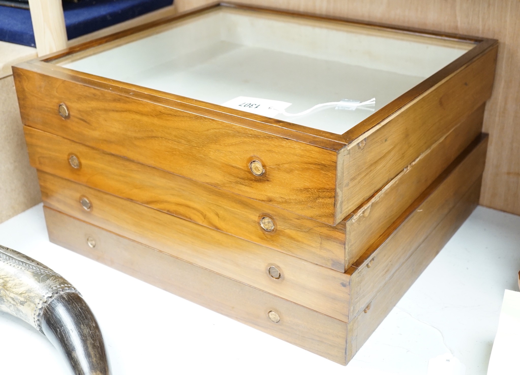 A set of four teak glass topped drawer collector's cases, 46cms wide x 40.5cms deep